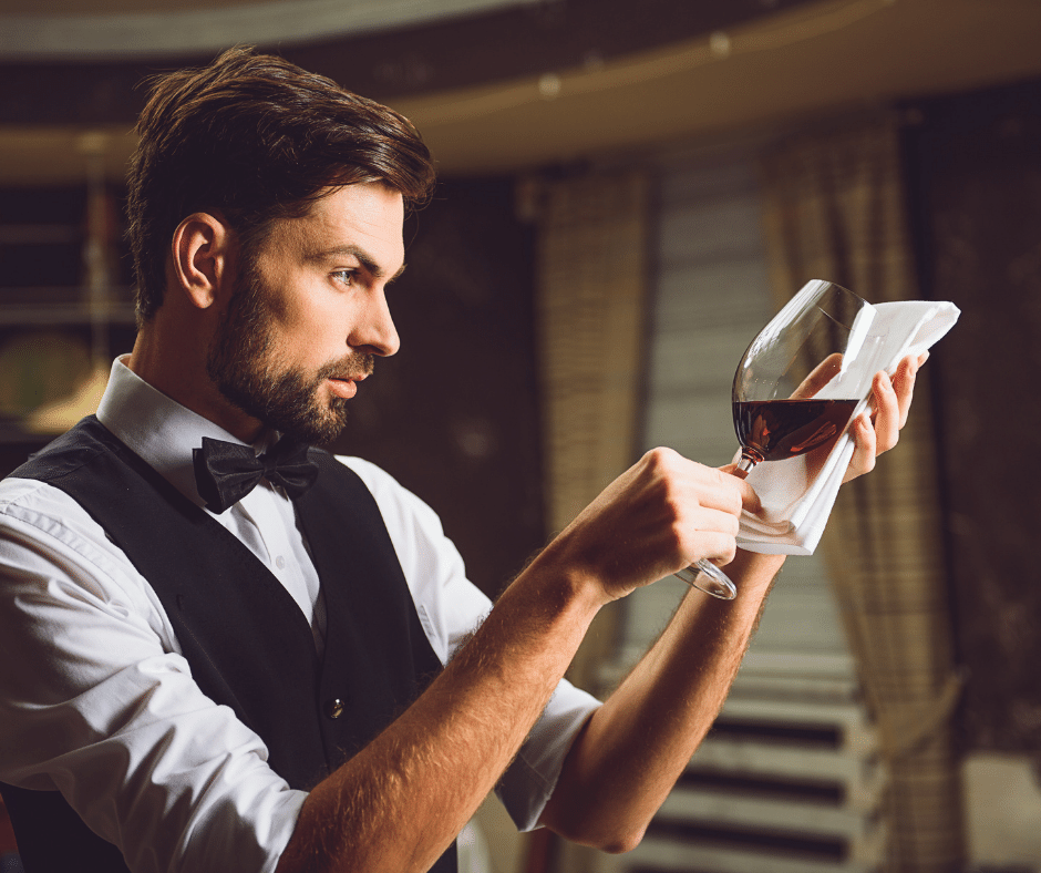 a waiter pouring wine