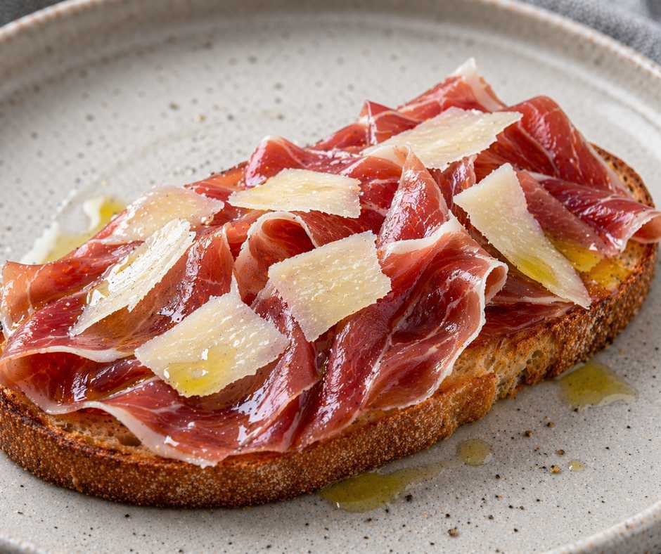 Jam&oacute;n serrano + shaved Manchego + extra virgin olive oil